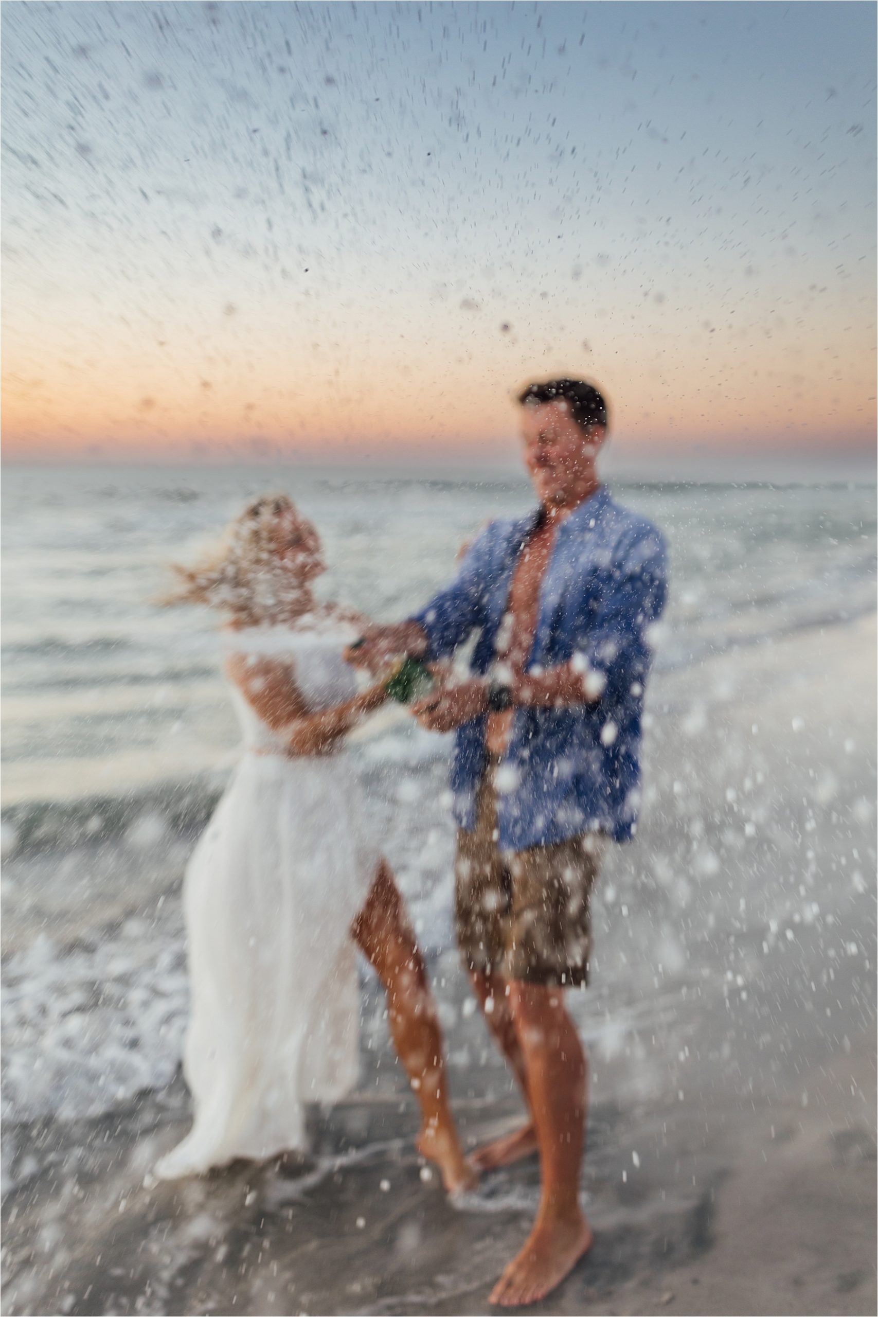 Champagne spray engagement photos