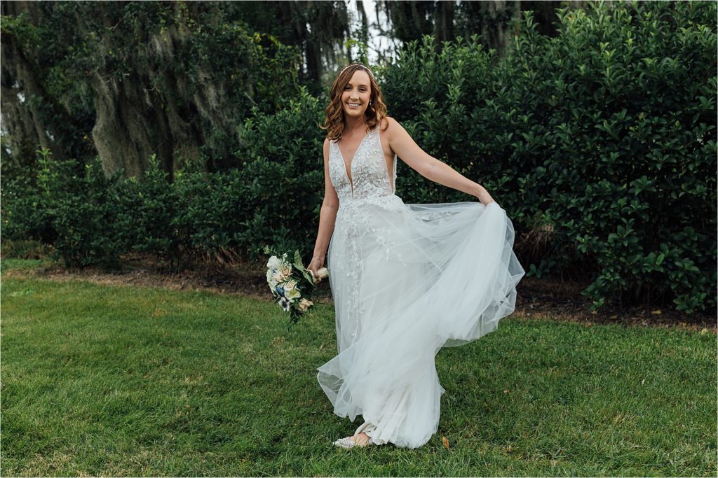 bride holding out wedding dress