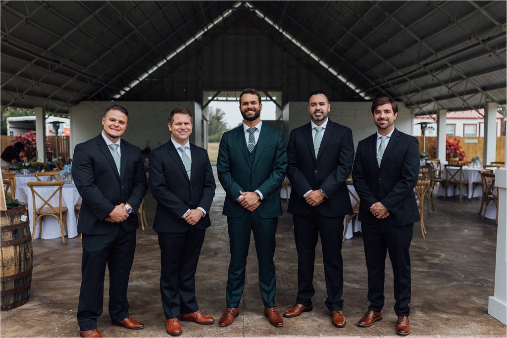groomsmen standing together smiling