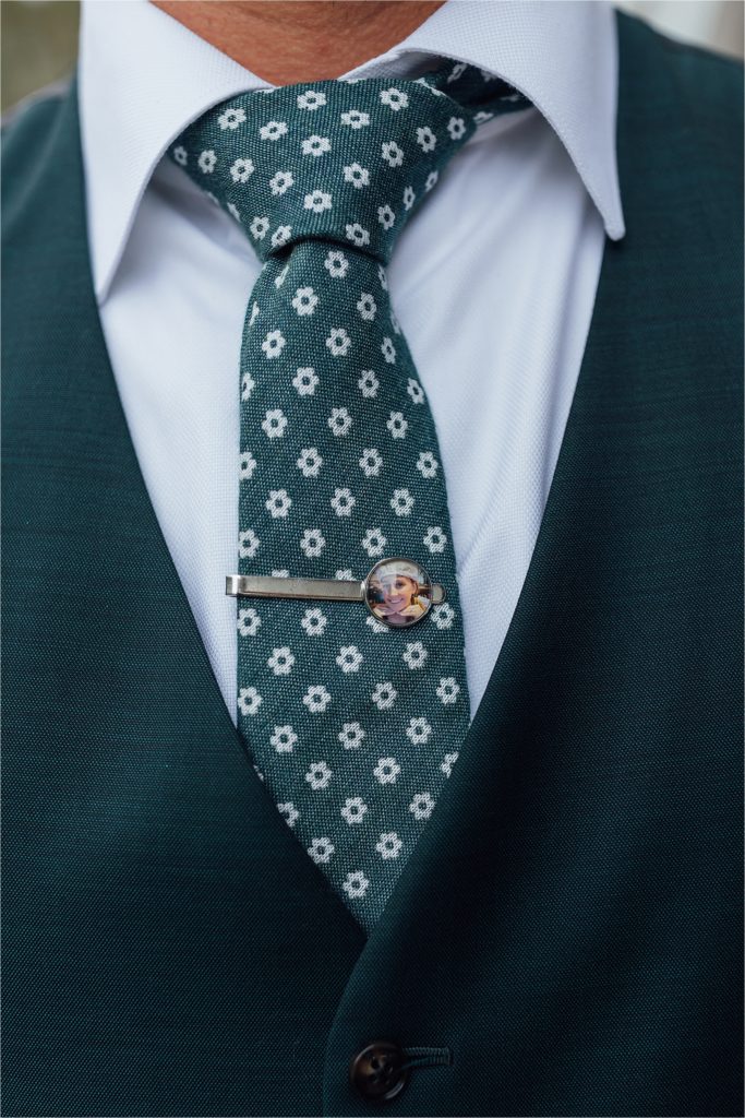 closeup of grooms tie and pin