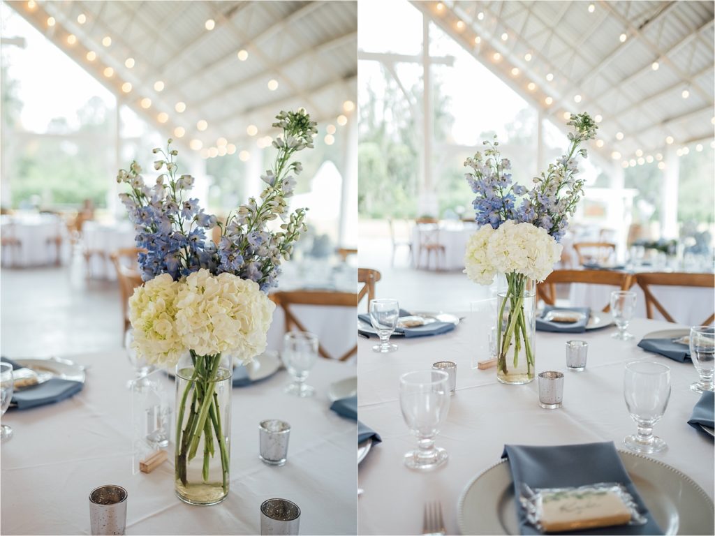 blue place settings with flowers in middle of table