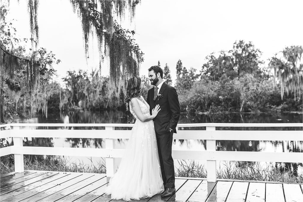 black and white of brie and groom looking at each other on outdoor patio