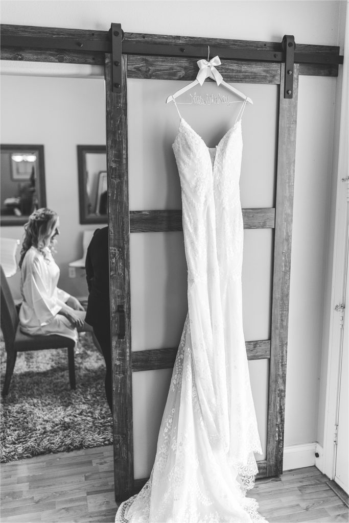 black and white of brides dress hanging up