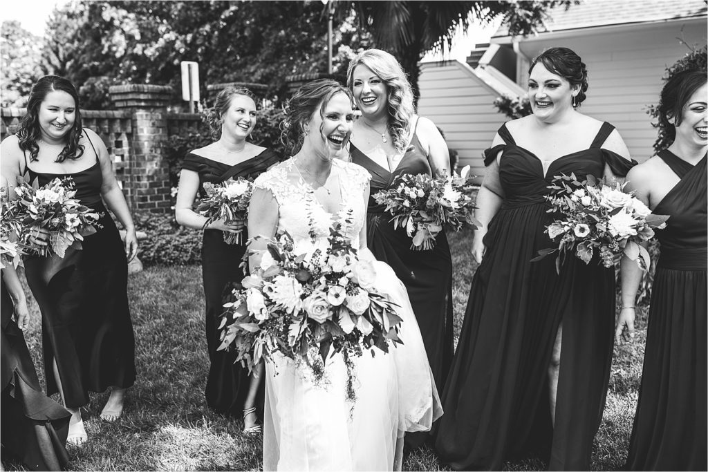 bride and bridesmaids laughing 