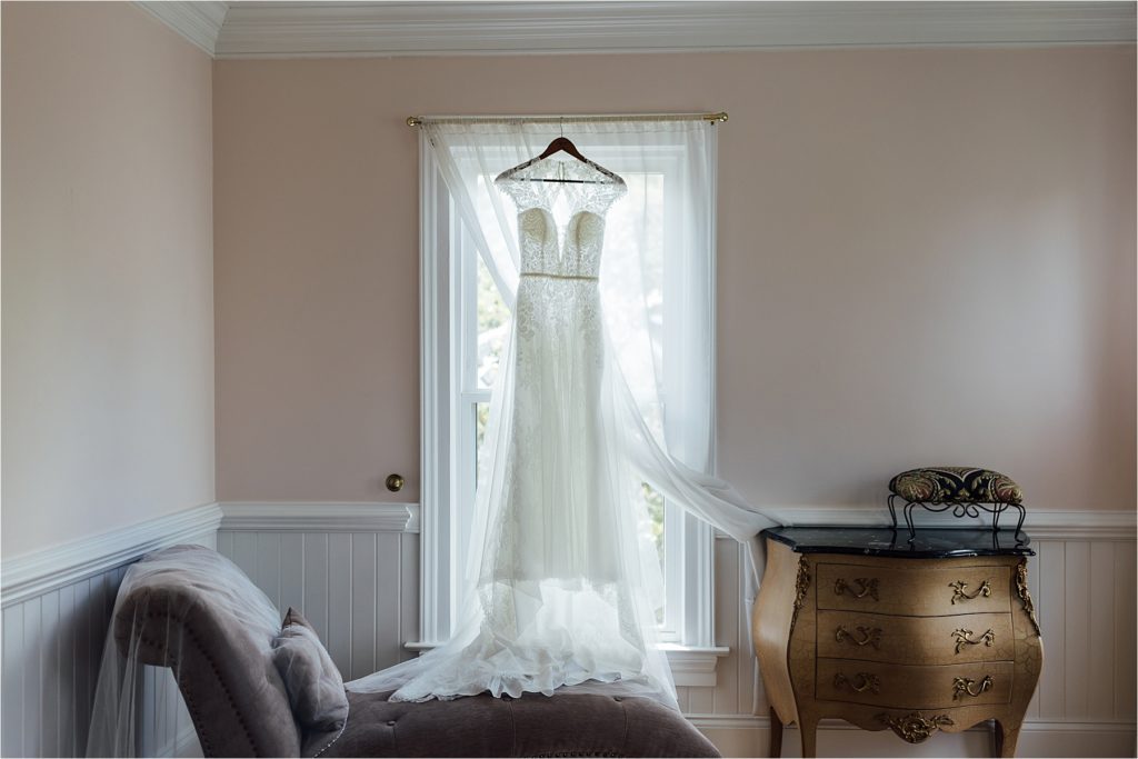 Wedding dress hanging in window frame