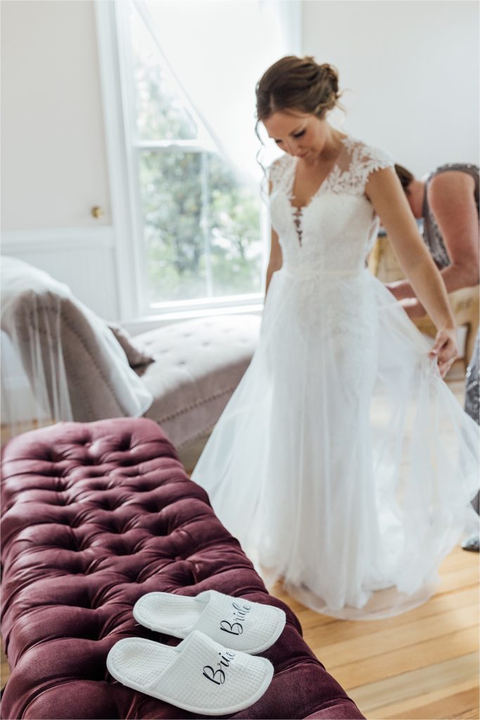 close up of bride slippers with bride in background